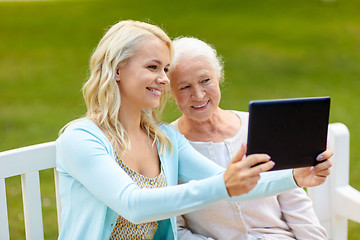 Image showing daughter with tablet pc and senior mother at park