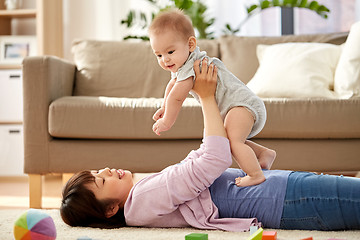 Image showing happy mother playing with little baby son at home