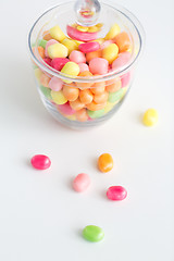 Image showing close up of glass jar with colorful candy drops