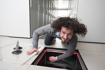 Image showing engineer connecting cables in server room