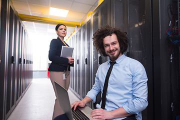 Image showing Team of young technicians working together on servers