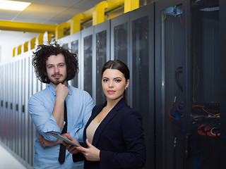 Image showing engineer showing working data center server room to female chief