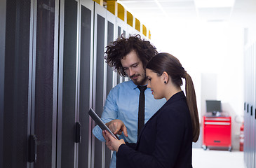 Image showing engineer showing working data center server room to female chief