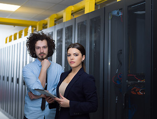 Image showing engineer showing working data center server room to female chief