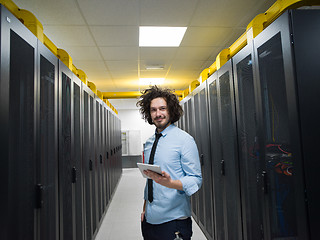 Image showing IT engineer working on a tablet computer in server room