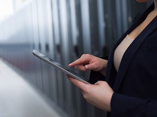 Image showing Female engineer working on a tablet computer in server room