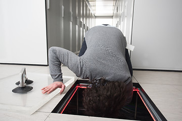 Image showing engineer connecting cables in server room