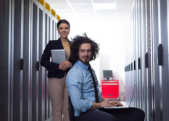 Image showing Team of young technicians working together on servers