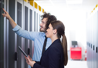 Image showing engineer showing working data center server room to female chief