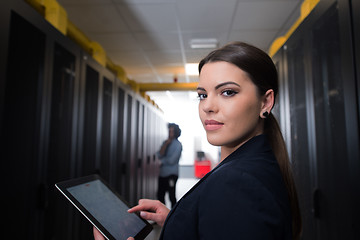 Image showing Female engineer working on a tablet computer in server room