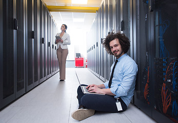 Image showing Team of young technicians working together on servers