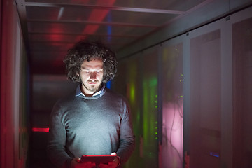 Image showing IT engineer working on a tablet computer in server room