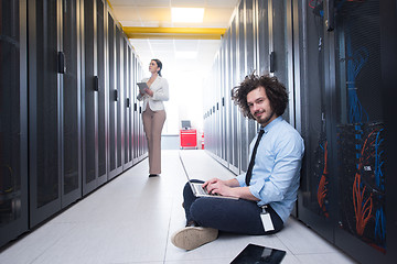 Image showing Team of young technicians working together on servers