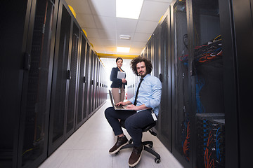 Image showing Team of young technicians working together on servers