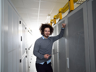 Image showing IT engineer working on a tablet computer in server room