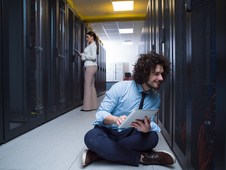 Image showing young technicians working together on servers