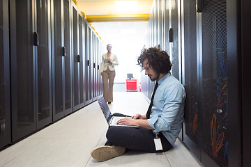 Image showing Team of young technicians working together on servers