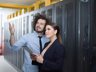 Image showing engineer showing working data center server room to female chief