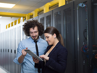 Image showing engineer showing working data center server room to female chief