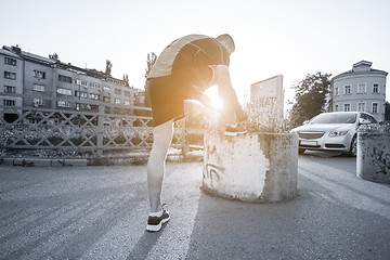 Image showing man tying running shoes laces