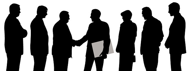Image showing Business group at a meeting shaking hands and one businessman holding folder with contract