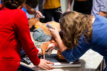 Image showing Medical doctor specialist expert displaying method of patient intubation on hands on medical education training and workshop. Participants learning new medical procedures and techniques.