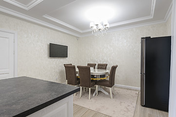 Image showing White luxury modern kitchen with dining table and island