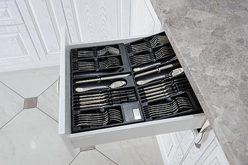 Image showing drawer with silver cutlery in modern white kitchen