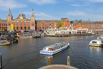 Image showing Sightseeng at Canal Boats next tot Central Station of Amsterdam