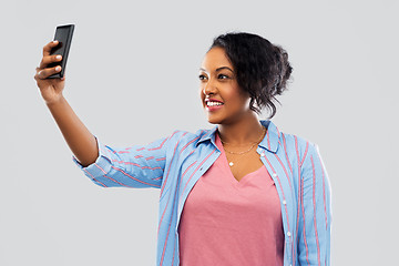 Image showing african american woman taking selfie by smartphone