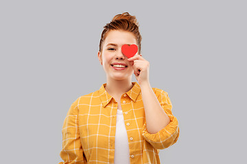 Image showing smiling red haired teenage girl with heart