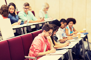 Image showing group of students with notebooks in lecture hall