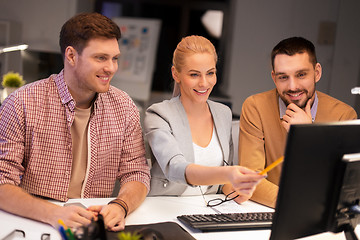 Image showing business team with computer working late at office