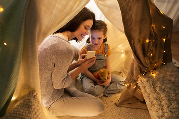 Image showing happy family with smartphone in kids tent at home