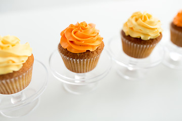 Image showing cupcakes with frosting on confectionery stands