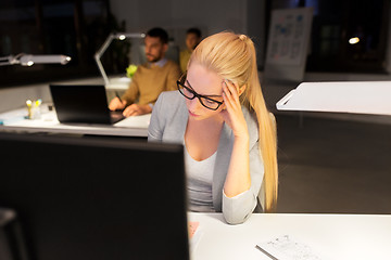 Image showing tired businesswoman working at night office