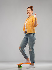 Image showing teenage girl with skateboard showing thumbs up