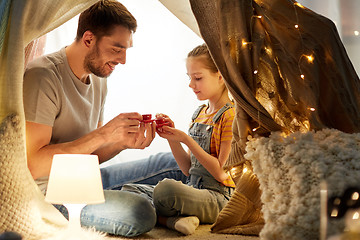 Image showing family playing tea party in kids tent at home