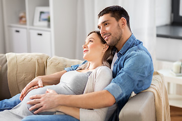 Image showing man hugging pregnant woman at home