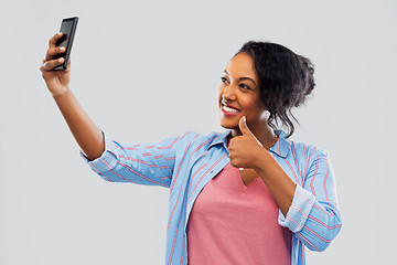 Image showing african american woman taking selfie by smartphone