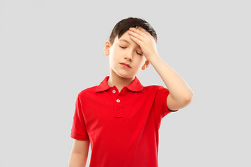 Image showing sick boy in red t-shirt suffering from headache