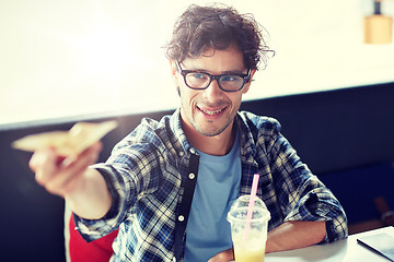 Image showing happy man with cash money paying at cafe