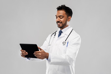 Image showing smiling indian male doctor with tablet computer