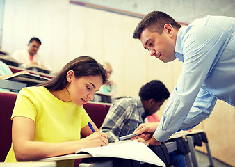 Image showing group of students and teacher with notebook