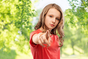 Image showing teenage girl in red t-shirt pointing finger to you