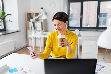 Image showing happy woman with coffee using smartphone at office