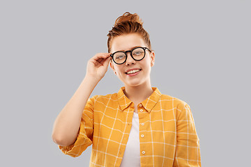 Image showing smiling red haired teenage student girl in glasses