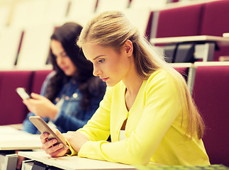 Image showing student girls with smartphones on lecture