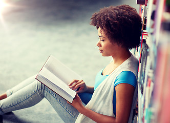 Image showing african student girl reading book at library