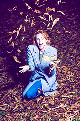 Image showing Portrait of a woman with autumn leaves.